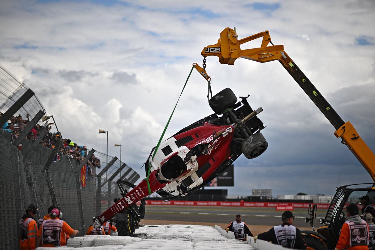 Stewards remove the crashed car of Alfa Romeo driver Zhou Guanyu from the barriers after a crash at the start of the Formula One British Grand Prix in Silverstone, U.K., July 3, 2022. Ben Stansall/VCG