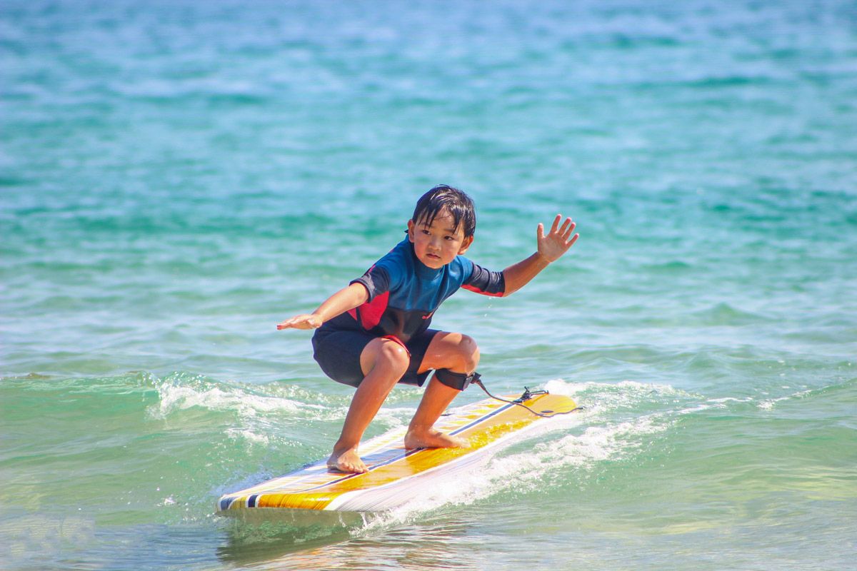 A boy learns surfing at Dynamode Surf Club in Hainan province. Courtesy of Dynamode