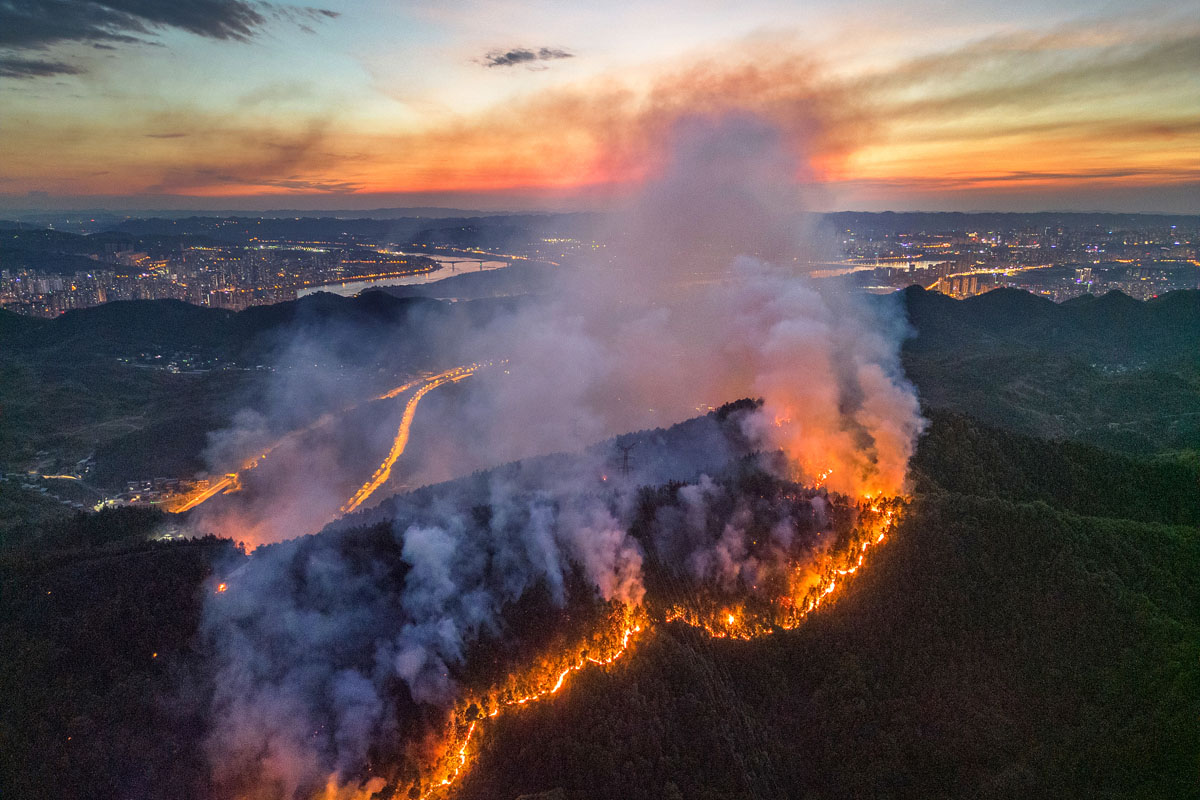 A view of a mountain fire in Chongqing, Aug. 23, 2022. A number of forest fires broke out in Chongqing due to the extremely dry and hot weather. VCG
