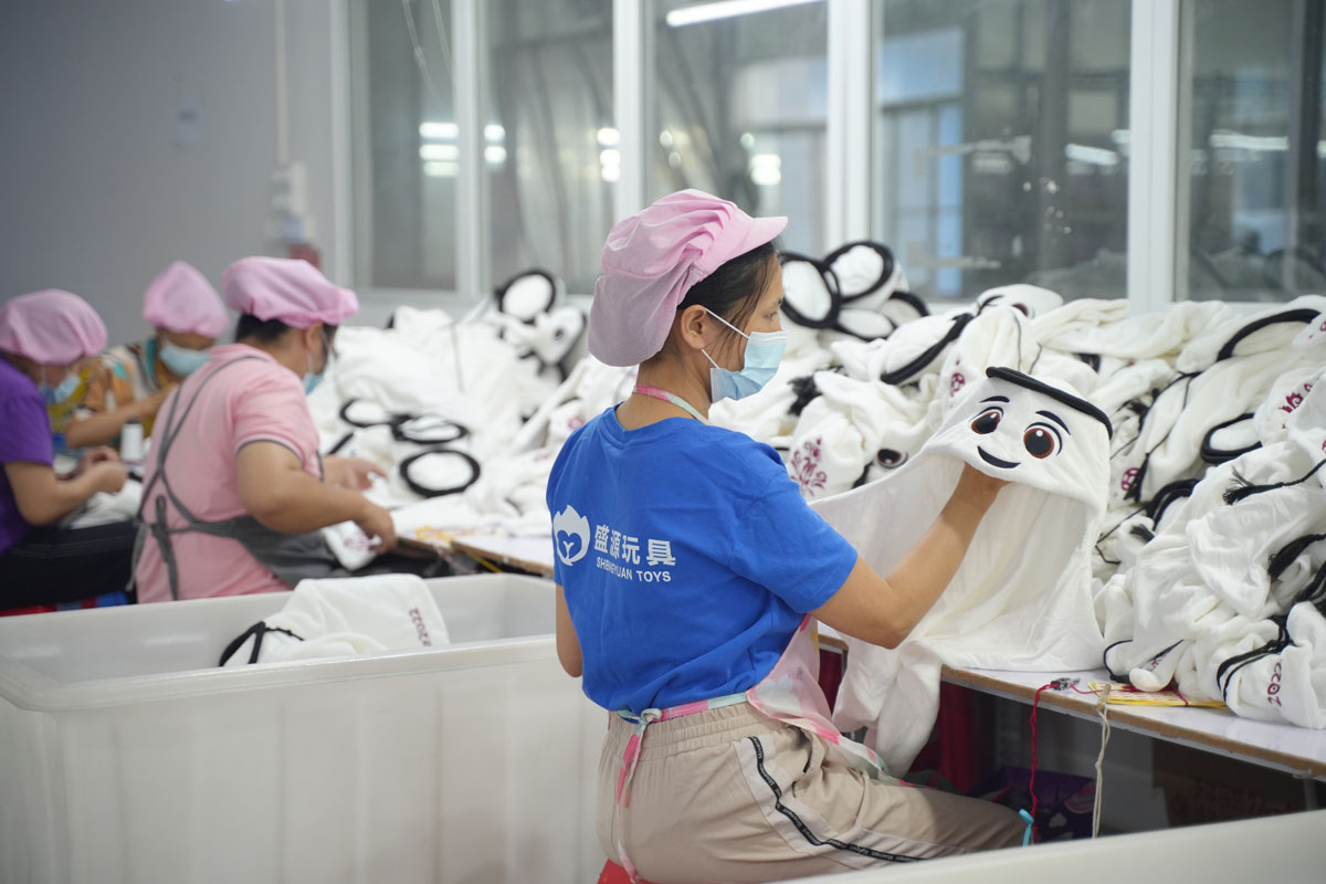 Workers make La’eeb toys, the official mascot of the 2022 FIFA World Cup, at a factory in Dongguan, Guangdong province, Nov. 15, 2022. VCG