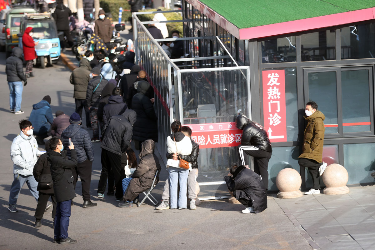 People wait in line at a fever clinic in Beijing, Dec. 9, 2022. VCG