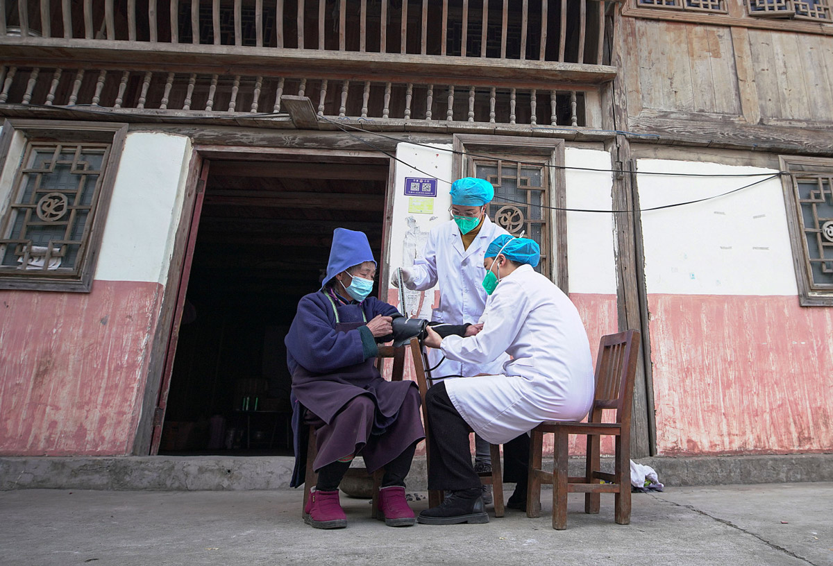 An elderly woman gets a COVID-19 vaccine outside her house in Qiandongnan Miao and Dong Autonomous Prefecture, Guizhou province, Dec. 12, 2022. IC