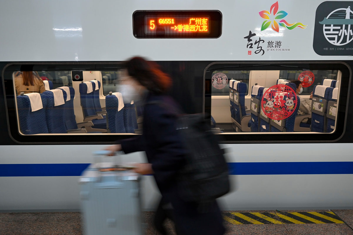 A woman rushes to board a train in Guangzhou, Guangdong province, Jan. 15, 2023. Chen Jimin/CNS via IC