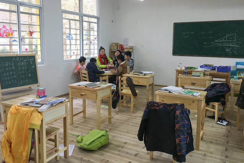 Five primary school students sit around a table in an English class at Chuyang School in Quzhou, Zhejiang province, Nov. 22, 2017. Ni Dandan/Sixth Tone