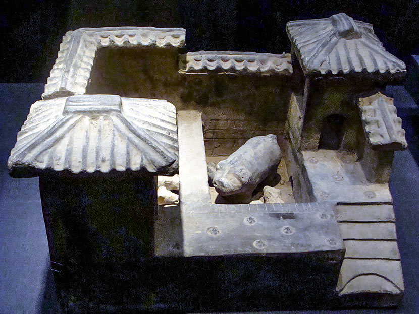 A grey pottery ‘pigsty’ from the Han dynasty during an exhibition in Haikou, Hainan province, Jan. 30, 2011. The middle and left parts are pigpens, while the right part is a toilet. Peng Tong/VCG