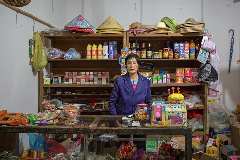 Shen Xiaoyan poses for a photo at her grocery store in Wencun Village, Fuyang, Zhejiang province, Nov. 16, 2017. Denise Hruby/Sixth Tone