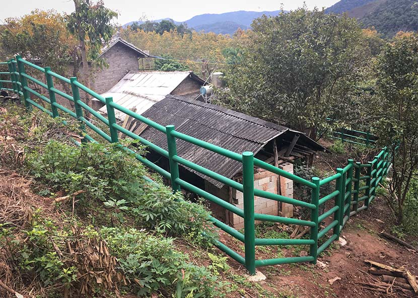 Anti-elephant barriers are installed around the houses of Wang Pingkang and four other families in Guanping Village, Yunnan province, Jan. 11, 2018. Wang Wanchun for Sixth Tone