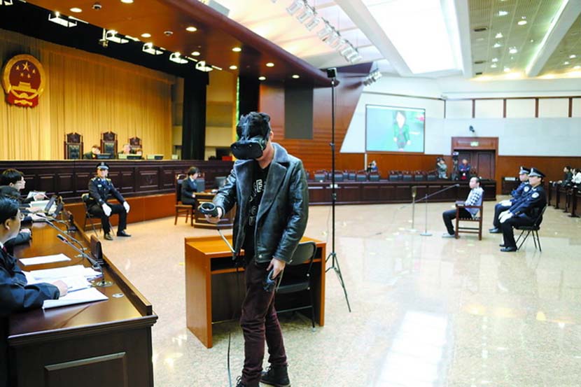A witness wearing a virtual reality headset re-enacts a crime during an intentional homicide trial in Beijing, March 1, 2018. From Weibo