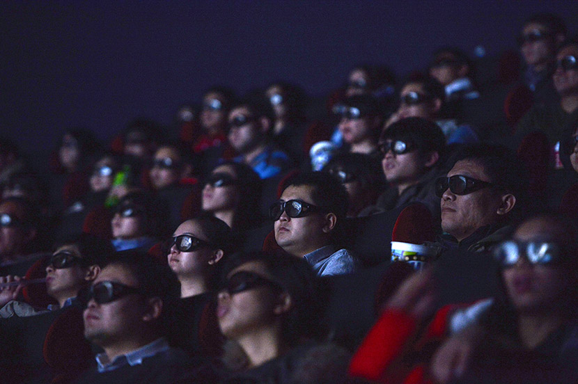 People watch a film at a cinema in Shijiazhuang, Hebei province, Nov. 24, 2013. Chen Jianyu/VCG
