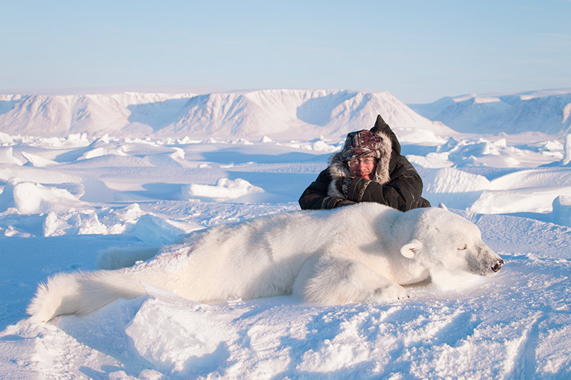 Wang Wei poses with a hunted polar bear in Canada, March 31, 2016. Courtesy of Zheng’an Safari Club
