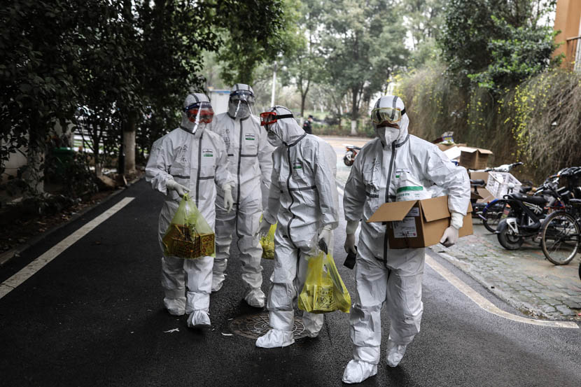 Medical staff deliver medicine to the quarantine center set up in the dormitories of Wuhan Vocational College of Software and Engineering in Wuhan, Hubei province, Feb. 27, 2020.  Zhao Di/China Youth Daily
