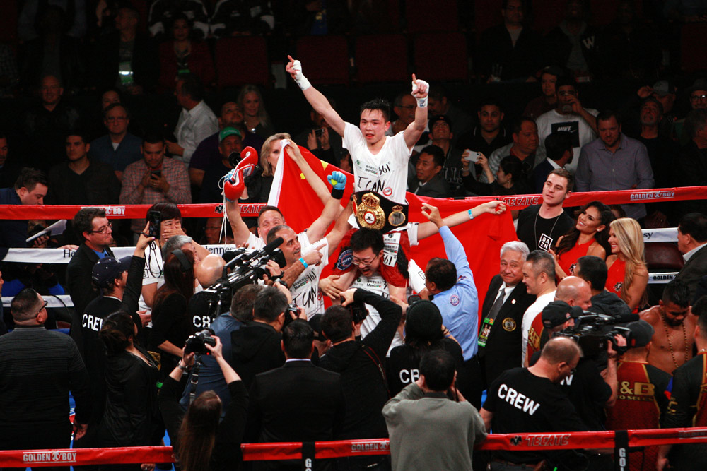 Xu Can is hoisted into the air after winning the WBA world title by defeating Jesus Rojas in Houston, Texas, 2019. Courtesy of Liu Gang