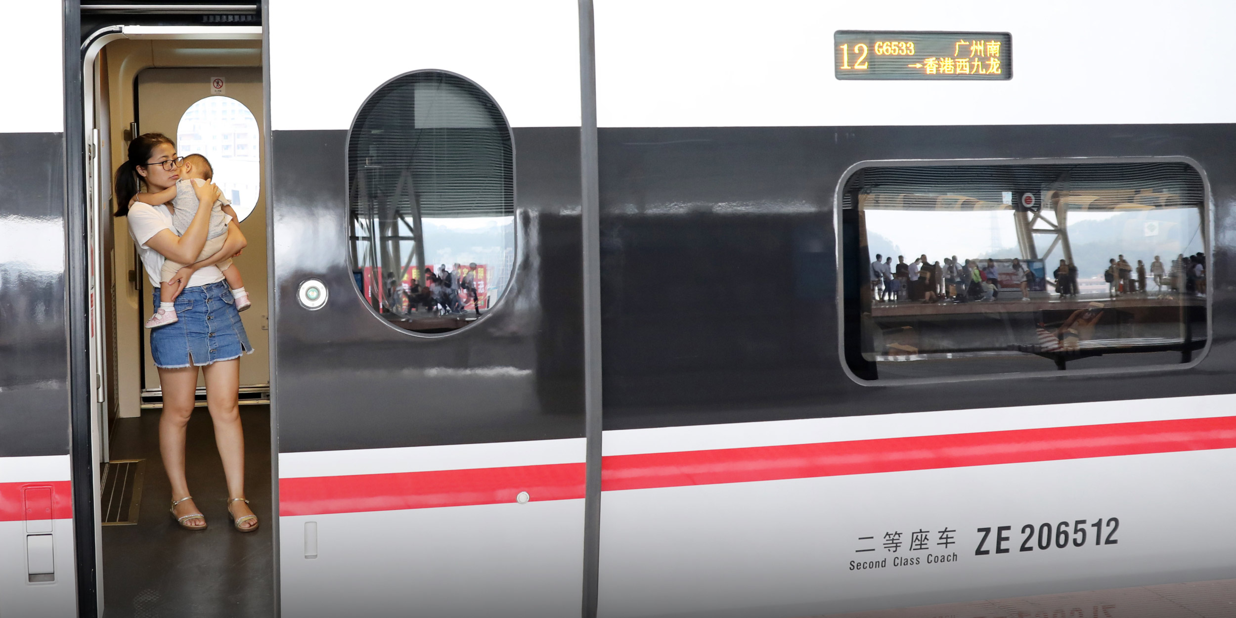 Students play online games inside a subway train in Beijing