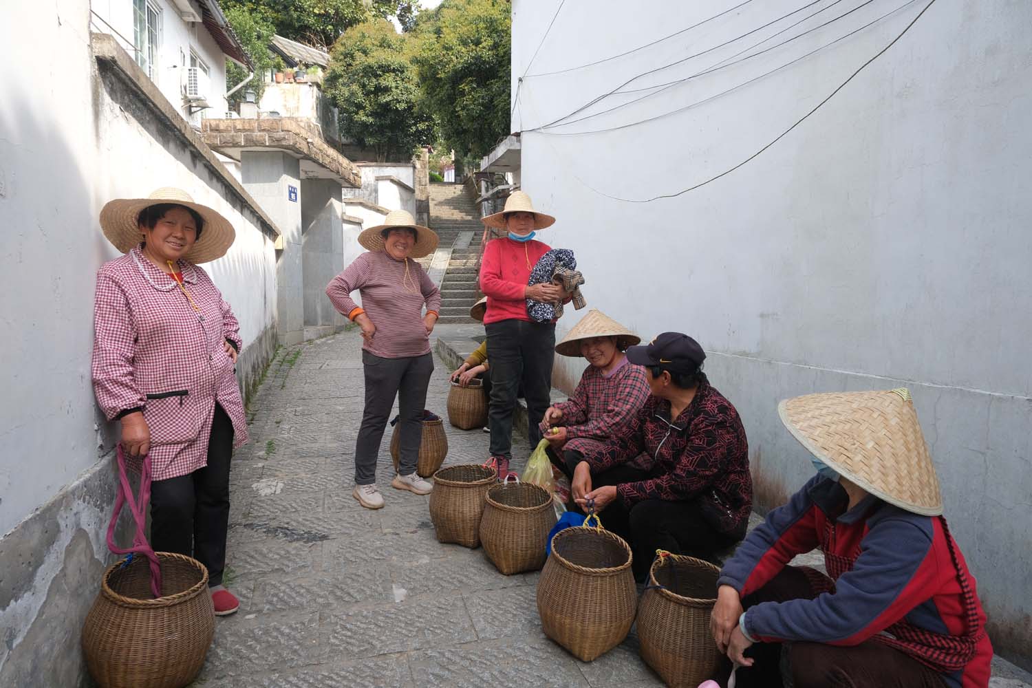 A group of tea pickers takes a break before heading to the next tea garden.